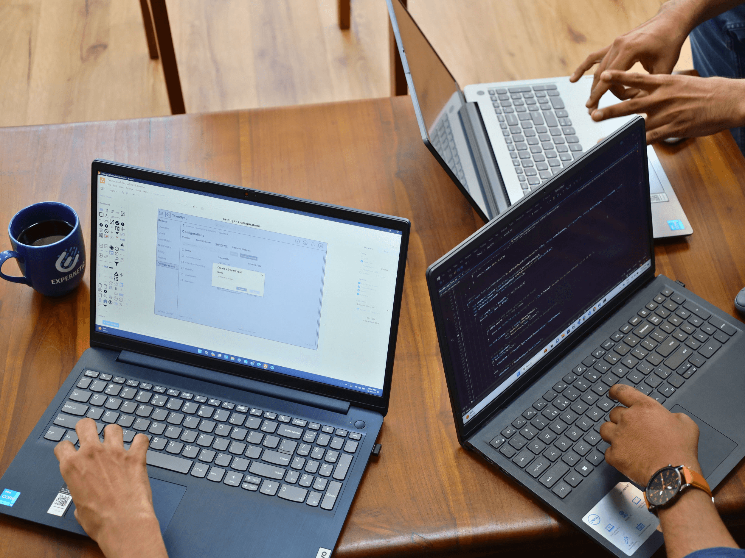 3 laptops side by side on a coffee table