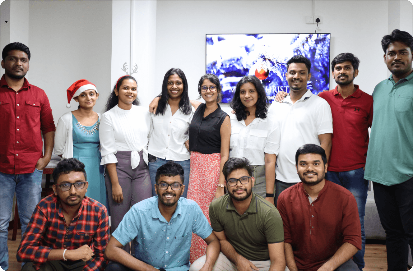 Group photo of company employees celebrating Christmas, wearing Santa hats